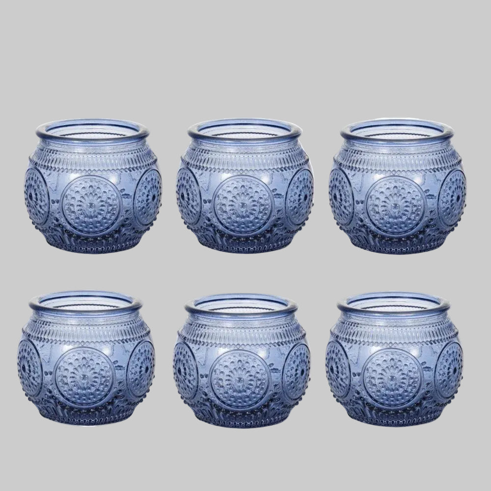 Blue glass tea light holder styled in a peaceful self care inspired space