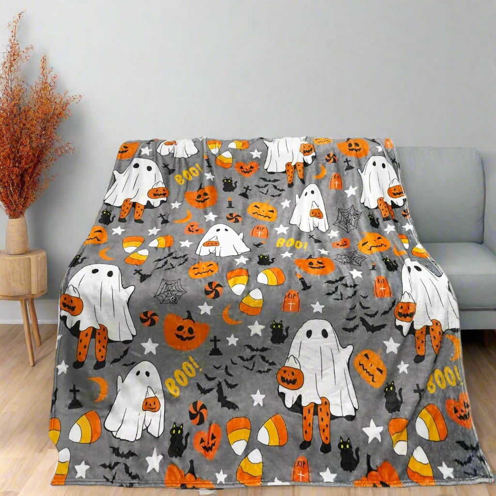 Grey fall throw blanket with playful ghost and pumpkin pattern for cozy homes