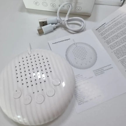 Portable white noise machine in white with lanyard, designed for calming sleep and stress relief