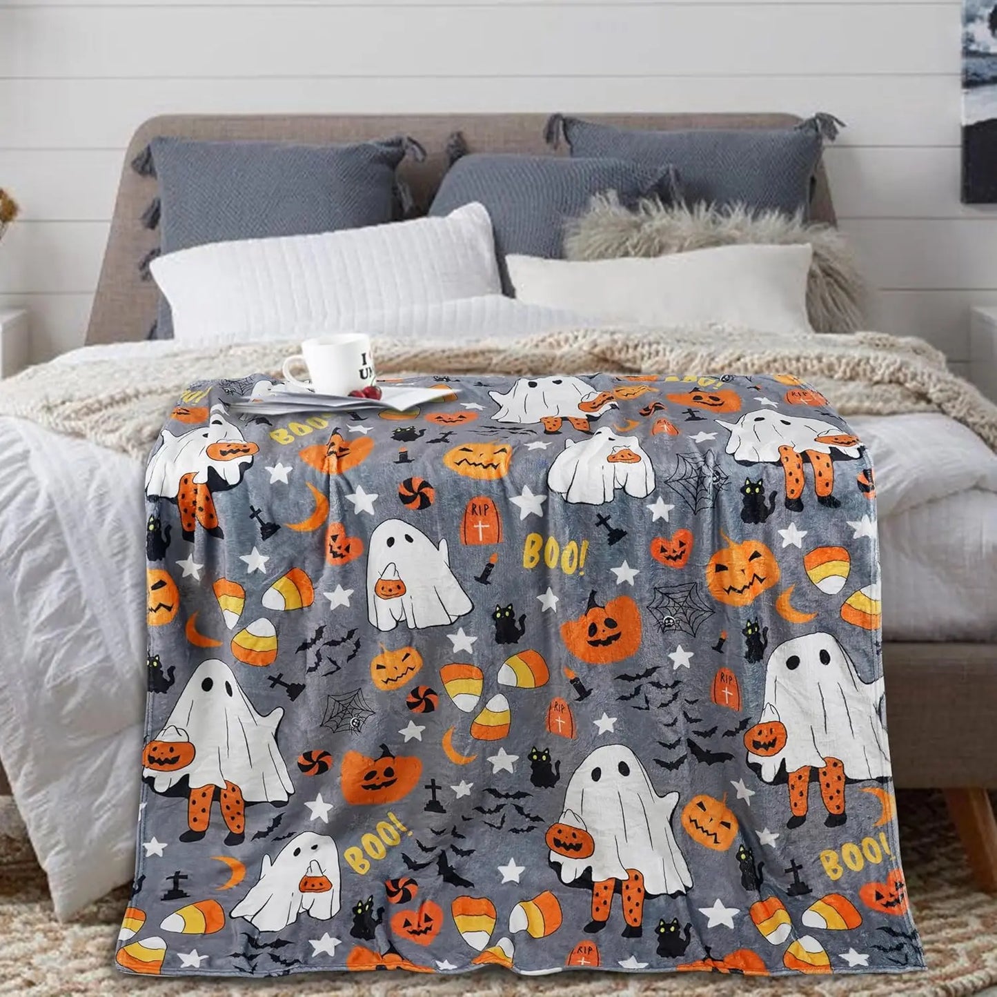Spooky cute ghost and pumpkin print blanket perfect for Halloween movie nights