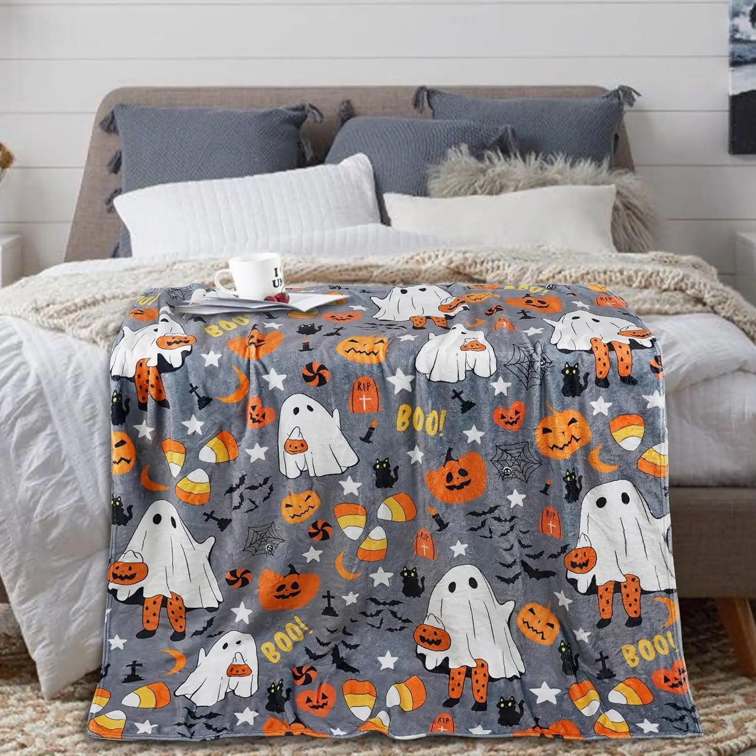 Spooky cute ghost and pumpkin print blanket perfect for Halloween movie nights
