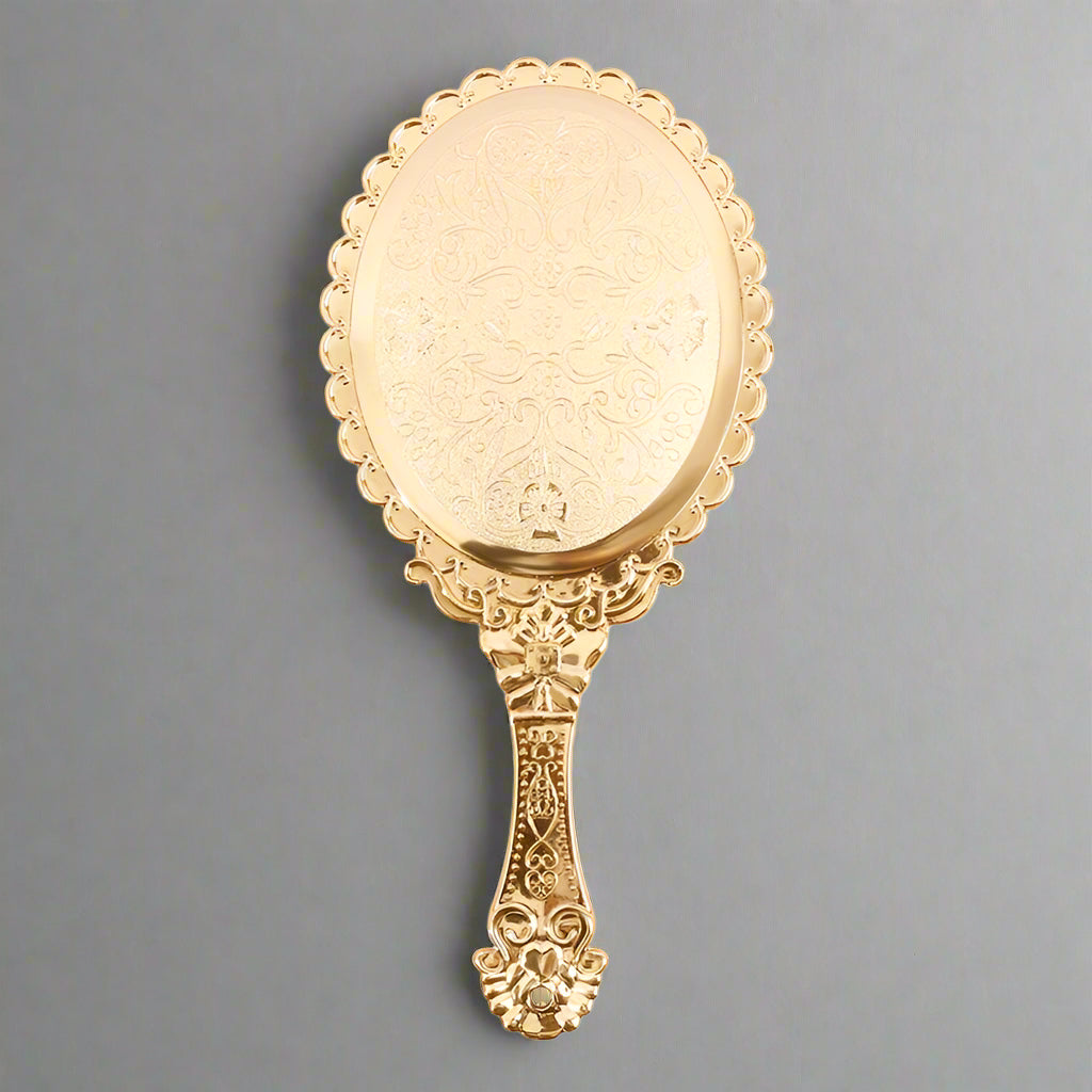 Victorian embossed oval hand mirror in rose gold, compact beauty essential for busy women